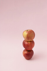Creative concept. Fresh red apple on pink background.