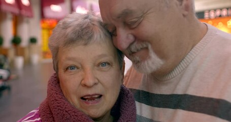 Close-up Portrait of an Elderly Couple in Love: Romantic Emotions in Mature Years. Beauty of affectionate relationships in later stages of life. Man kisses a woman in Valentine's Day celebration.