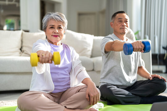 Portrait sport senior asian couple training and sitting relax practicing yoga, elderly health, fitness, exercise, wellness, workout, sport at home.retirement concept.Fitness and senior healthy