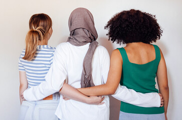 Strong female friendship. Rear view ttree teen girls best friends holding hands