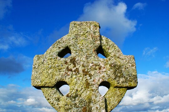 Old Celtic cross on sky background. Stone cross. High quality photo