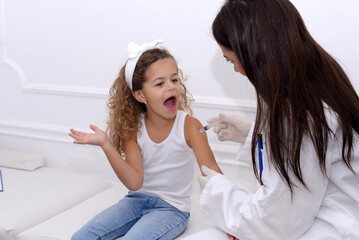 Child of preschool age receives a vaccine in the doctor's office