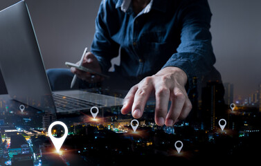 Mark the location of the address on a GPS map or mobile app. A man is using a laptop and a tablet...