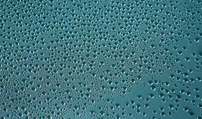 Condensation waterdrops on a blue surface        