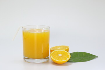 glass of orange juice and orange on white background
