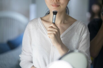 Woman applying make up with blush
