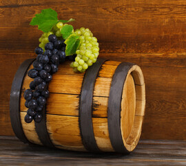 Still life with barrel decorated red and white grapes