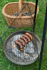 Sausages being barbequed in a garden - 704376603