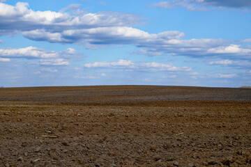A clear day over freshly tilled agricultural land.