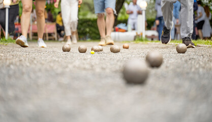 Bocce players collect metal boules on court petanque french outdoor game 