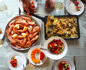 The top view on a table with food and white wine