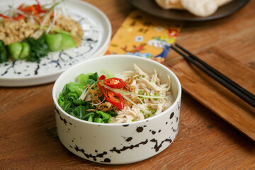 Foods to eat on Lunar New Year’s Eve on the table with golden envelope stuffed with money as a token of good fortune in the New Year.