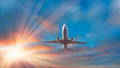 Fototapeta na wymiar Airplane flying over stormy tropical sea at sunset