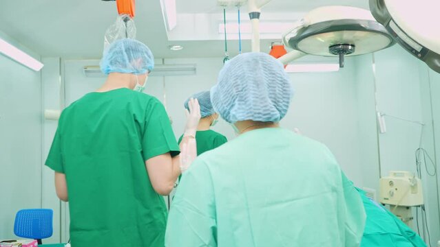 Professional surgeons team performing surgery in the operating room, surgeon, Assistants, and Nurses Performing Surgery on a Patient, health care cancer and disease treatment concept