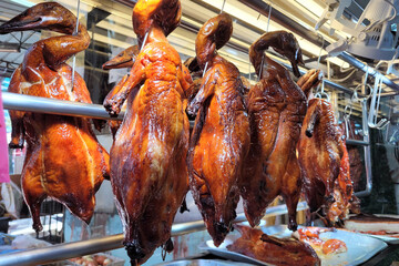 Naklejka premium Roast duck hanging in the window, Chinese food.
