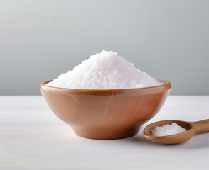 Wooden Bowl Filled With White Rice Next to a Wooden Spoon