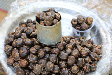 Pile of waternut or Chinese water chestnut in galvanized glass for sale in the market in the north of Thailand