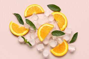 Orange slices with ice cubes and mint on beige background