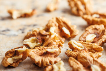 Peeled dried walnut kernels on kitchen table.