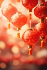 Chinese lanterns hang on a red Chinese New Year background.