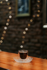 an expresso coffee shot closeup inside a cozy coffeeshop