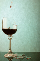 Poisonous Drops in a Shattered Glass on a Picturesque Turquoise Background