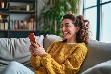 Young happy woman using mobile cell phone sitting on couch at home. Smiling cheerful lady laughing holding smartphone having fun while buying in ecommerce shop or watching funny videos, Generative AI 