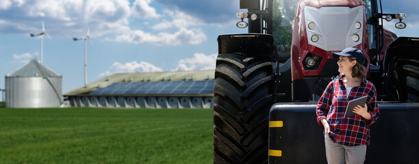 Woman farmer with a digital tablet and agricultural tractor on a background of modern farm.