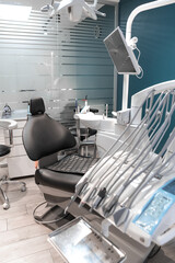 An empty dental office in which the patient's chair, prepared for the appointment, demonstrates a...