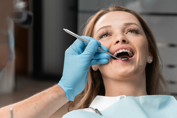 Like a true expert, the doctor examines each tooth in detail, assessing the condition of the...