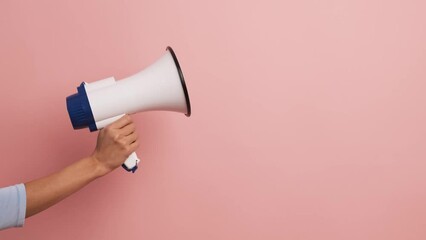Cropped image of a female hand holding a loudspeaker