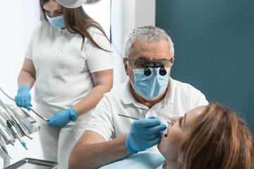 Dentist and assistant work together to ensure highest level of treatment for patient. Their...
