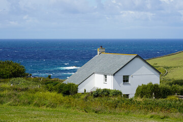 Fototapeta na wymiar Cottage with sea views, along the coastal path near the Lizard Point in Cornwall, England