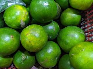 Lot of green lime on the bucket grocery store. Lat Citrus × aurantiifolia. The photo is suitable to use for fruit and vegetable background and promotion content media.