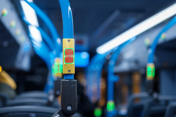Closeup of a stop button inside of a european style commuter bus