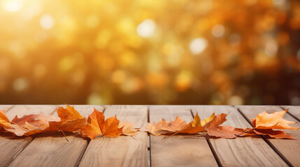 Naklejka na ściany i meble bokeh background wooden table with orange fall leaves autumn natural