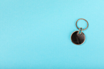 Keychain with key ring isolated on a colored background. Concepts for real estate and moving home or renting property. Buying a property. Mock-up keychain.Copy space.