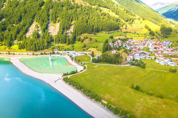 Curon Venosta. Submerged bell Tower in Graun im Vinschgau on Lake Reschen Alpine landscape aerial view - 704422664