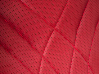 Part of leather car headrest seat details. Сlose-up red   perforated leather car seat. Skin texture