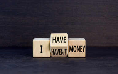 I have or not money symbol. Concept word I have or have not money on beautiful wooden cubes. Beautiful black table black background. Business and i have or not money concept. Copy space.