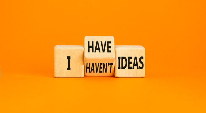 I have or not idea symbol. Concept word I have or have not ideas on beautiful wooden cubes. Beautiful orange table orange background. Business and i have or not idea concept. Copy space.