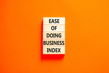 Ease of doing business index symbol. Concept words Ease of doing business index on wooden blocks. Beautiful orange table orange background. Business, ease of doing business index concept. Copy space.