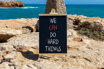 We can do hard things symbol. Concept words We can do hard things on beautiful blackboard. Beautiful stone sea background. Business, we can do hard things concept. Copy space.