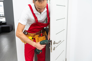 Young man worker confident repairing door at home