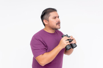 Side view of a man looking confused upon seeing something mysterious with his binoculars. Speechless and dumbstruck expression. Wearing a purple waffle shirt, isolated on a white background.