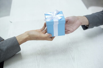 Cropped Hand Of Man Giving Gift Box To Woman
