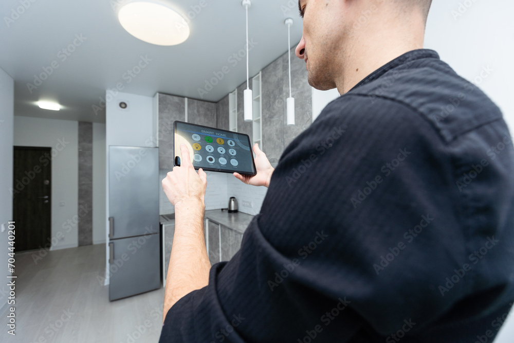 Aufkleber worker with tablet computer checking alarm system indoors