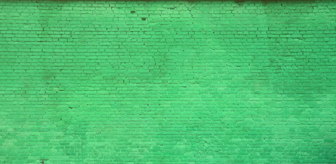 The texture of the brick wall of many rows of bricks painted in green color
