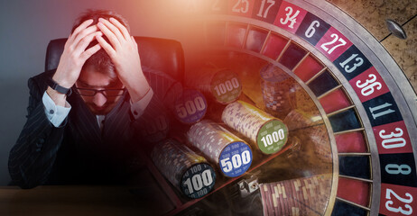 Sad player in casino. Man and roulette table. Guy went bankrupt because casino. Problem gambling addiction. Human gambling addict sits clutching head. Guy went bankrupt due to gambling addiction - obrazy, fototapety, plakaty
