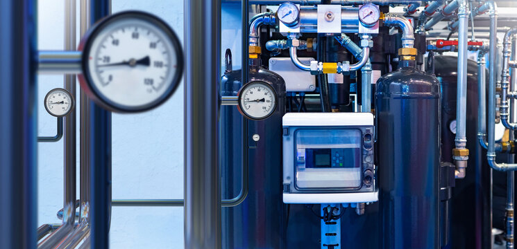 Industrial gas equipment. Compressor station to supply factory with propane. Gas equipment with pipes and manometers. Workshop of industrial chemical enterprise. Petroleum products processing